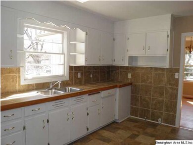 Eat-in Kitchen has lots of cabinets and new tile c