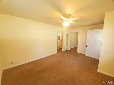 Unfurnished bedroom with carpet floors, a closet, and a ceiling fan
