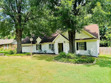 View of front of house featuring a garage and brick siding
