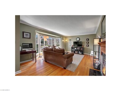 Spacious living room has large bow window to lets 