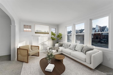 Living area with carpet, arched walkways, and ornamental molding