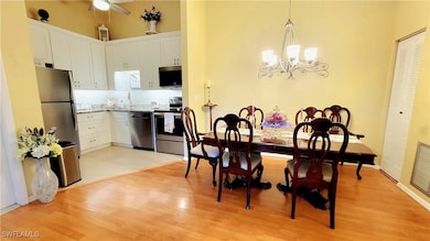 Dining room with a towering ceiling, visible vents