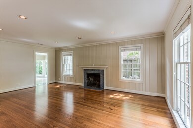 Formal living room has one paneled wall and fireplace with marble surround and mantel.  True oak hardwood floors throughout first and second floors.