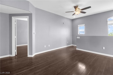 Empty room with a ceiling fan, baseboards, and woo