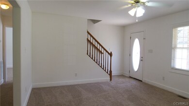 Living room with new carpet and ceiling fan