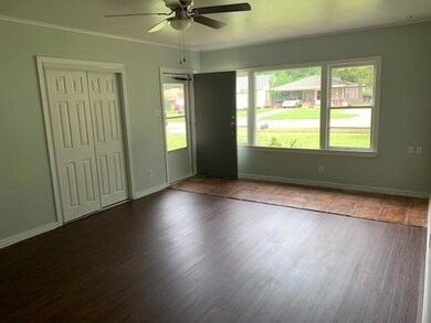 Spare room featuring crown molding, ceiling fan, a