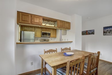 Dining area with wood finished floors and baseboar