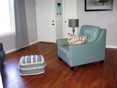 Walk into this lovely living room with hardwood fl