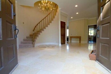 Double Door front entry with travertine floors