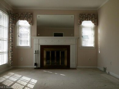 Spacious front living/family room with fireplace. 