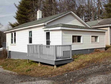 The back view of the home highlights the side deck