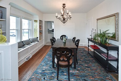 Dining space featuring a notable chandelier and dark wood-type flooring