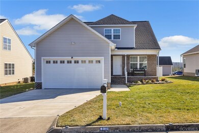 View of property featuring a garage and a front la