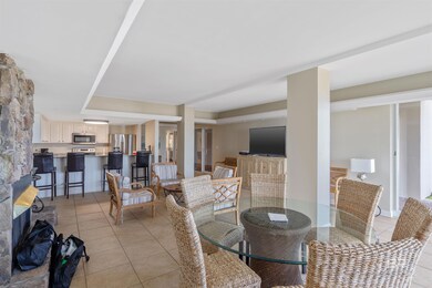 Tiled dining room featuring a raised ceiling