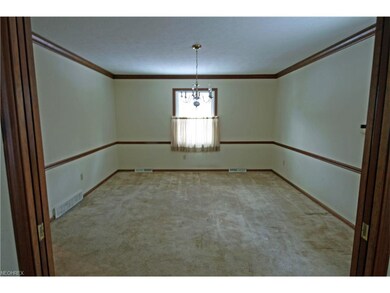 Dining room with crown molding and chair rail. Poc