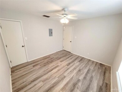 Unfurnished bedroom featuring electric panel, light wood finished floors, and ceiling fan