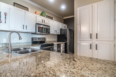 The kitchen seamlessly connects to the dining and living areas.