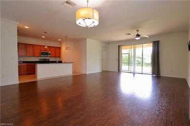 Unfurnished living room featuring crown molding, wood finished floors, recessed lighting, and ceiling fan
