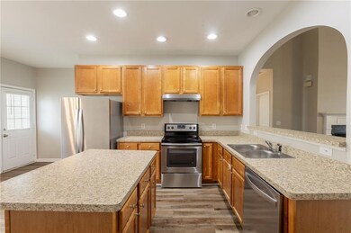 Kitchen with under cabinet range hood, stainless s