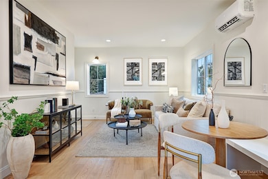 Sunlight fills a functional, open main level outfitted with engineered hardwood floors, mini-splits for heat and A/C, and a sleek chef's kitchen.