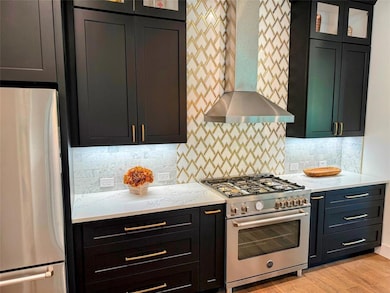 Kitchen featuring appliances with stainless steel