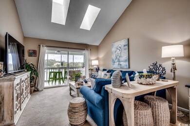 Living area with high vaulted ceiling, a skylight,