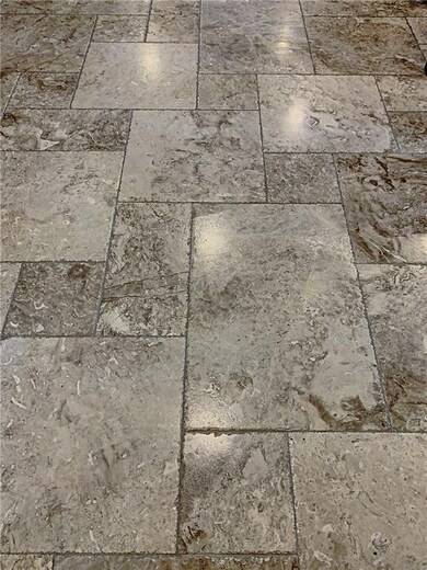 Close up of the chipped-edge marble flooring which