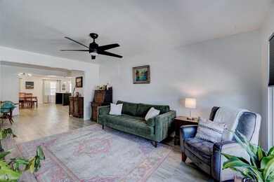 Living room with light wood-type flooring and ceil