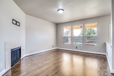 Unfurnished living room with wood finished floors and a fireplace