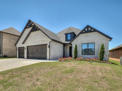 French country inspired facade with a garage, brick siding, driveway, a front yard, and roof with shingles