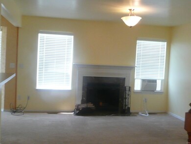 Living room, fireplace, small window unit was just