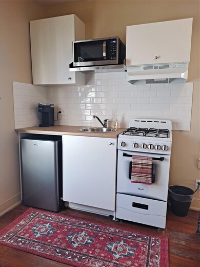 Kitchen featuring range, refrigerator, wood finis