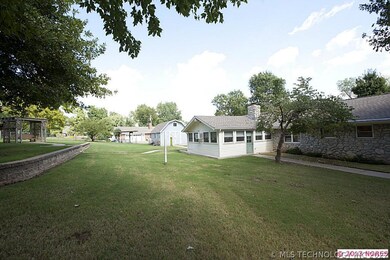 Spacious backyard features charming arbor with wic