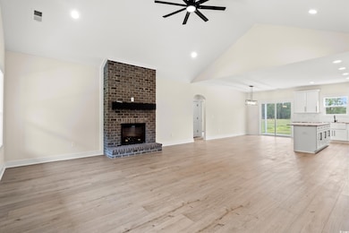 Unfurnished living room with high vaulted ceiling,