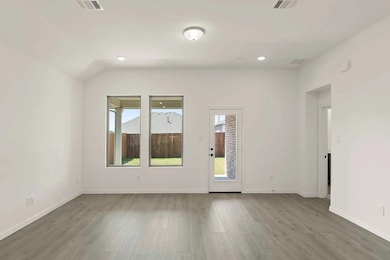 Empty room featuring wood finished floors and recessed lighting