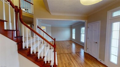 Impressive foyer with grand staircase and hard woo