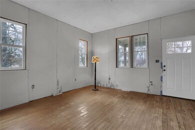 Spacious living room waiting for your finish touch. Hardwood floor will be awesome once finished.