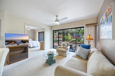 Living room with ceiling fan and carpet floors