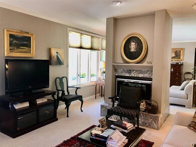 Carpeted living room featuring ornamental molding 