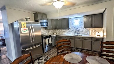 Beautifully remodeled kitchen.  All new cabinets, tile backsplash, deep stainless sinks, now fixtures, built in microwave, disposal, new vinyl plank floors, oven range and hardware.