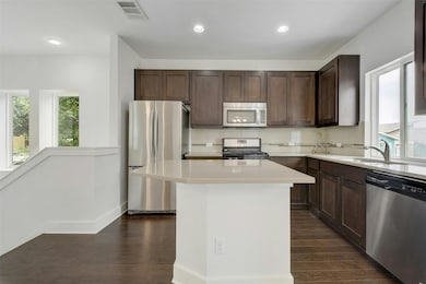 Kitchen with stainless steel appliances, a sink, 