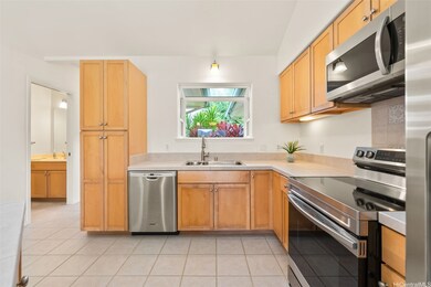 Well-appointed kitchen with several new appliances and a charming bay window overlooking the lush tropical plants in the front courtyard. The powder room (i.e. half bath) is conveniently located on the main floor along the entryway.