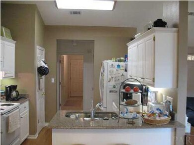 Kitchen with quartz countertops and breakfast bar.