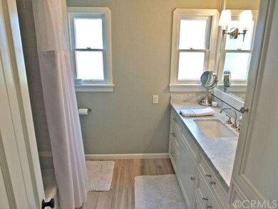 Hall full bathroom with light wood flooring, light