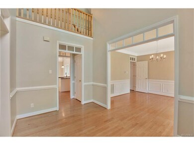 2-Story foyer with wood floor, chair rail, transom