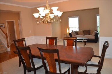 Dining room with trey ceiling open to living room