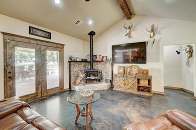 Living room featuring lofted ceiling with beams, a