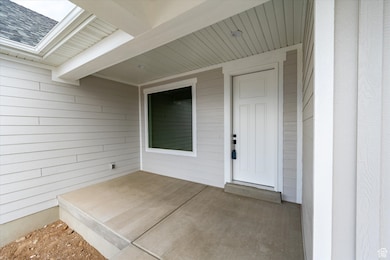 Doorway to property with roof with shingles