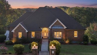 View of front of house with a front yard and brick siding
