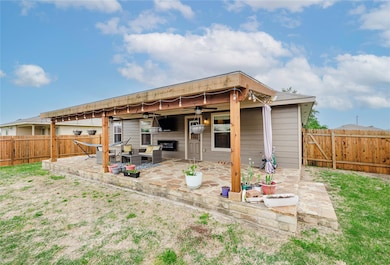 Back of house with a ceiling fan, a fenced backyard, and a patio
